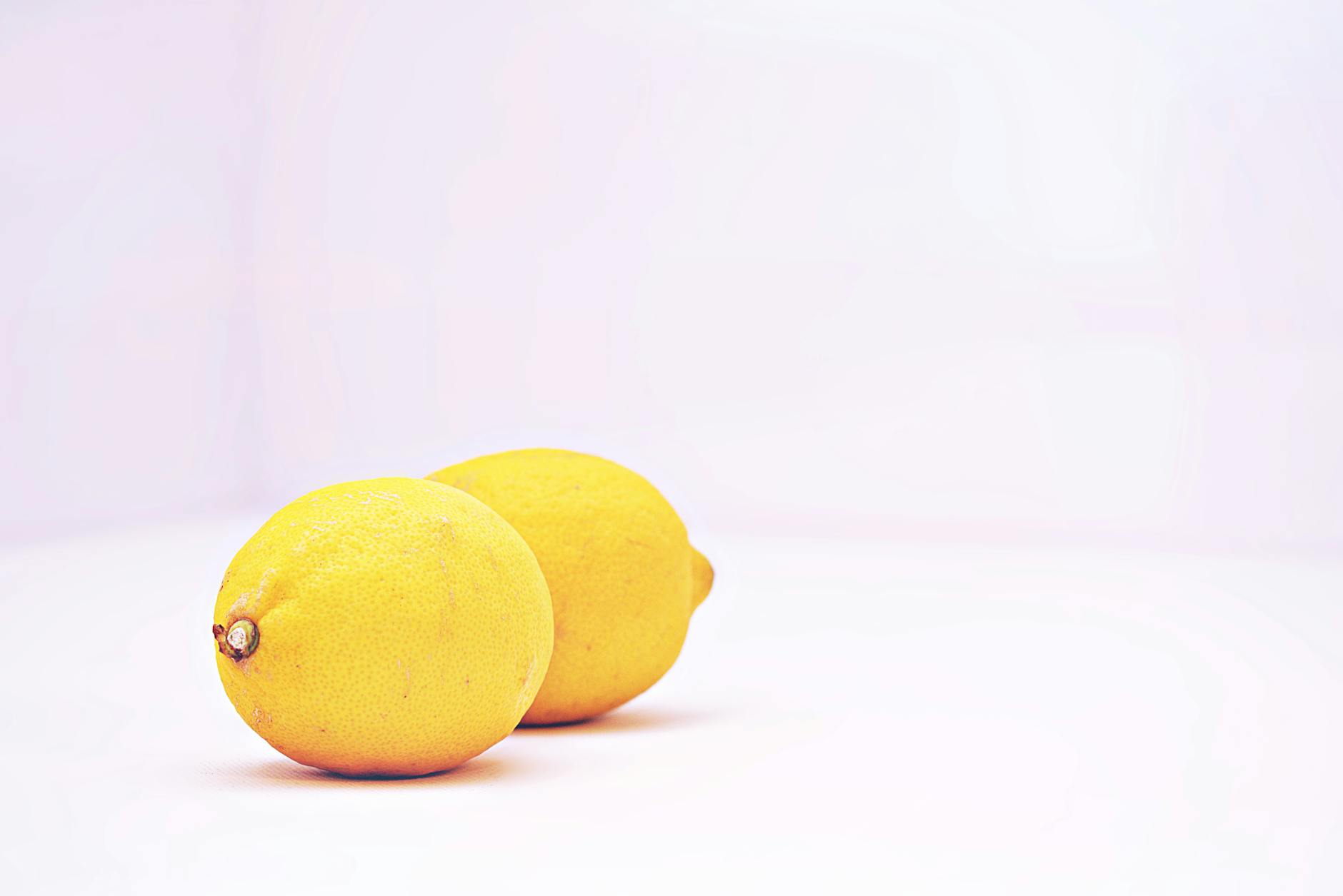 Two vibrant lemons on a white background, representing fresh approaches to pelvic health and sensation