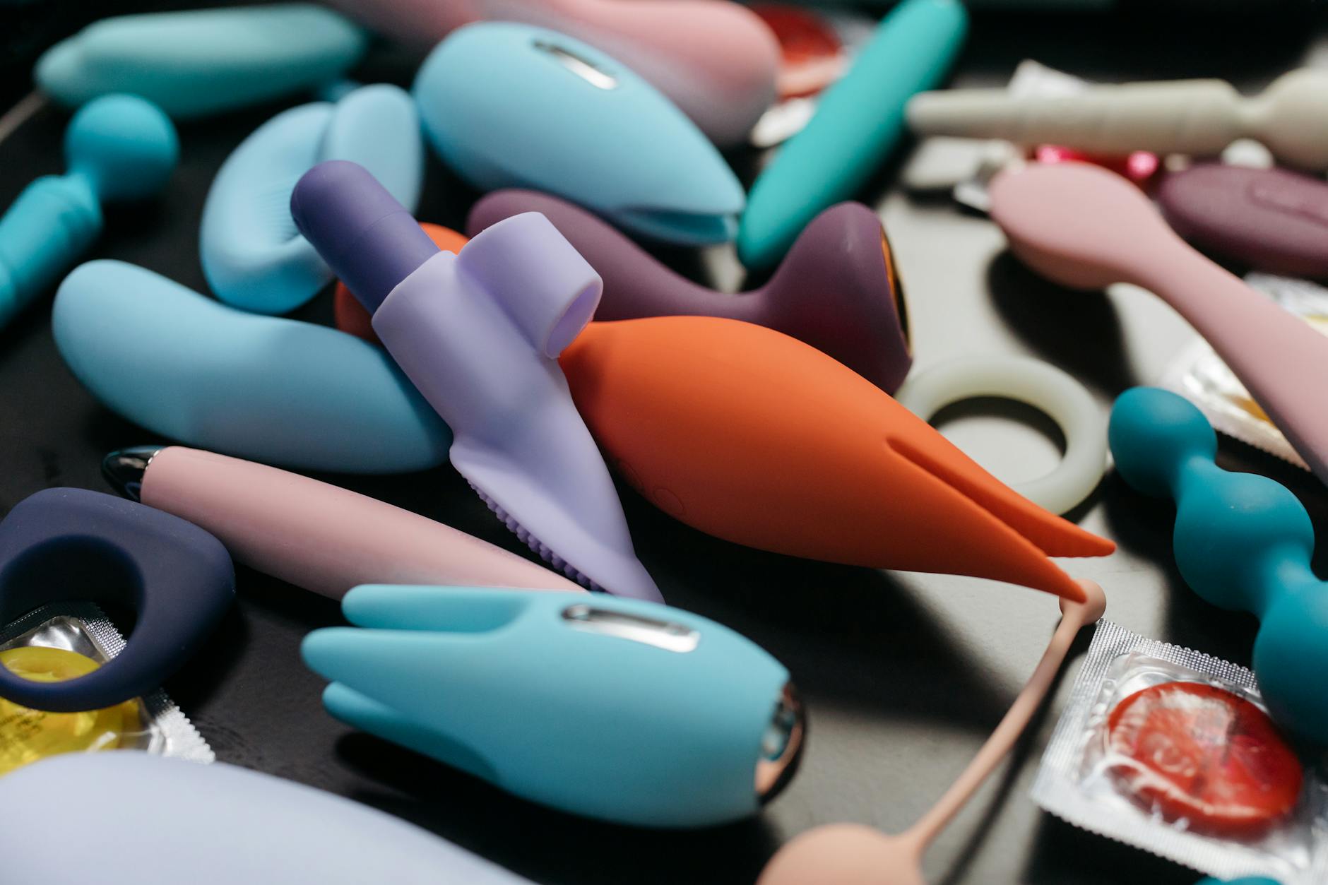Colorful vibrators and intimate wellness toys arranged in a close-up view